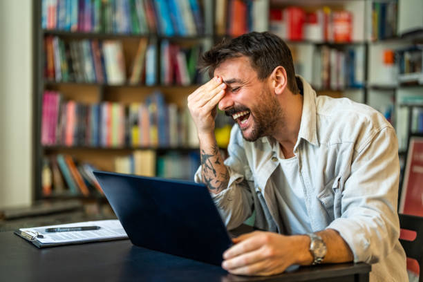 Excited man celebrating success, reading good news in email