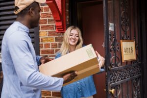 Photo by Mizuno K: https://www.pexels.com/photo/smiling-woman-receiving-package-from-courier-13443801/