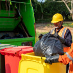 Professional workers handling garbage bins during Waste removal services Kent WA, ensuring efficient waste collection, sorting, and eco-friendly disposal with proper safety gear and recycling practices.