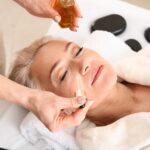 A woman receiving a rejuvenating treatment with essential oils during an anti-aging facial near me, enhancing skin hydration, reducing fine lines, and restoring youthful glow.