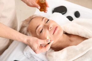 A woman receiving a rejuvenating treatment with essential oils during an anti-aging facial near me, enhancing skin hydration, reducing fine lines, and restoring youthful glow.