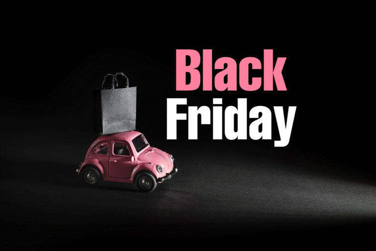 Pink toy car carrying a shopping bag with Black Friday sale text on dark background