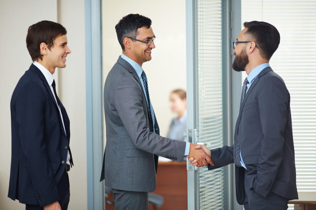 Businessmen shaking hands to symbolize trust and authenticity in digital marketing partnerships.