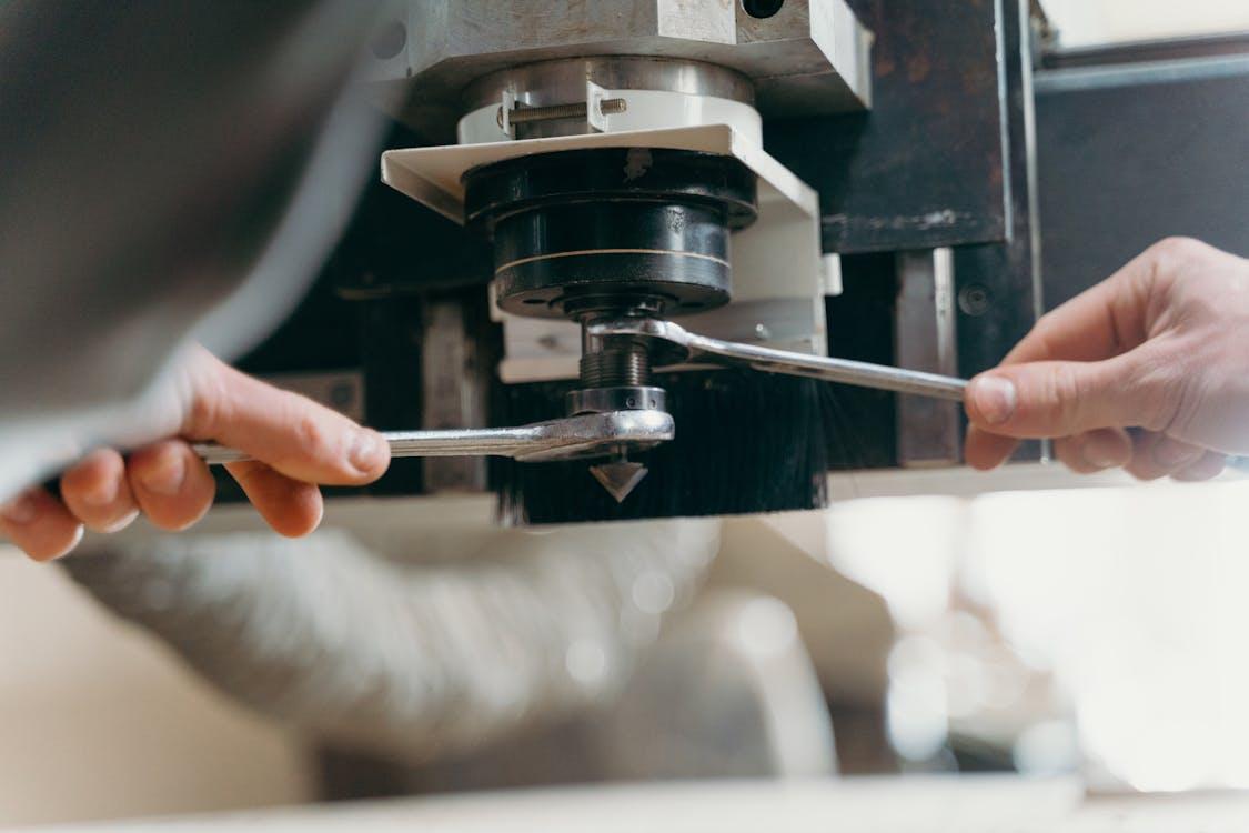 Close up of a technician holding and inspecting a machine