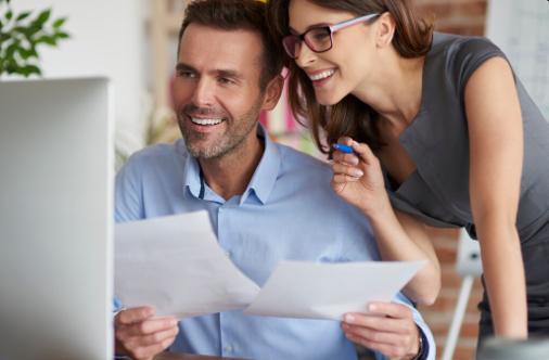 Team of professionals collaborating at a desk discussing loan terms