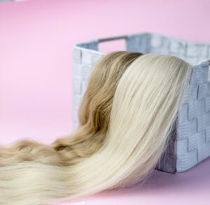 Two sets of wigs placed in a basket.