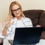 A woman at home engaging in a virtual consultation with a licensed provider