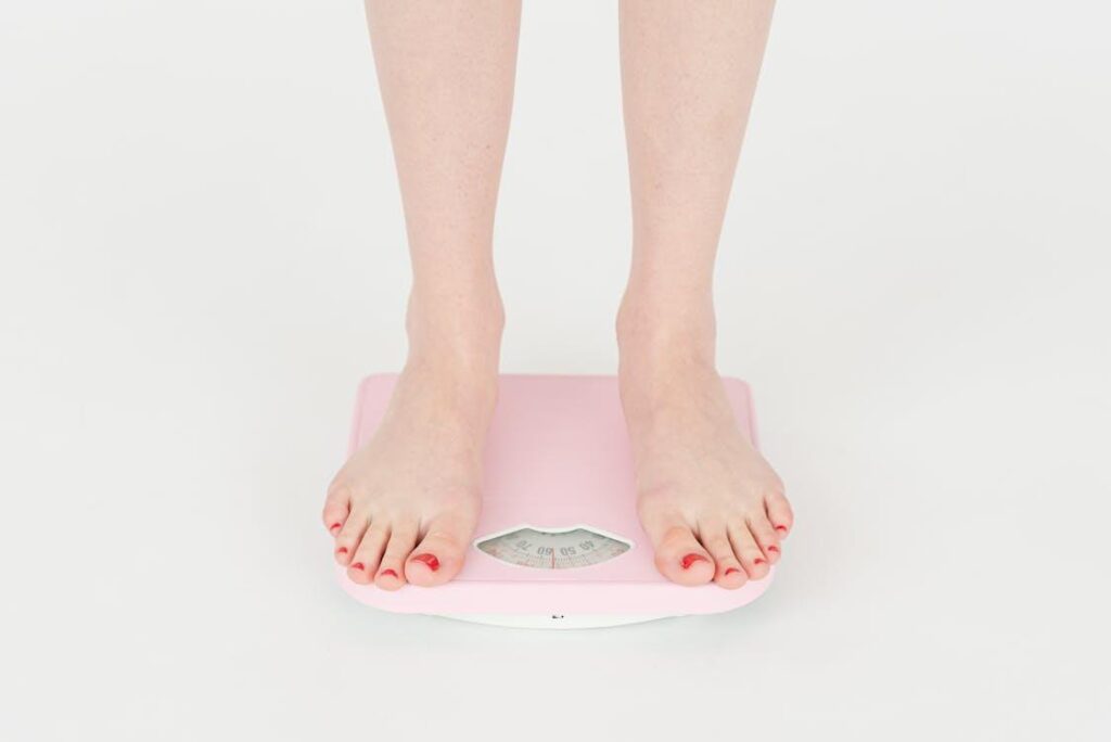 A person weighing themselves on a scale