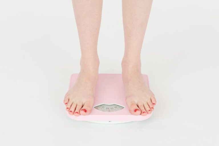 A person weighing themselves on a scale