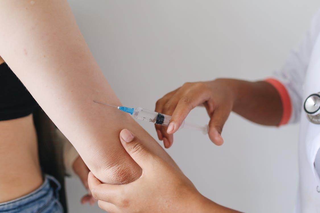 A person being injected with weight loss drugs