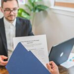 Investor presenting loan paperwork to a lending professional