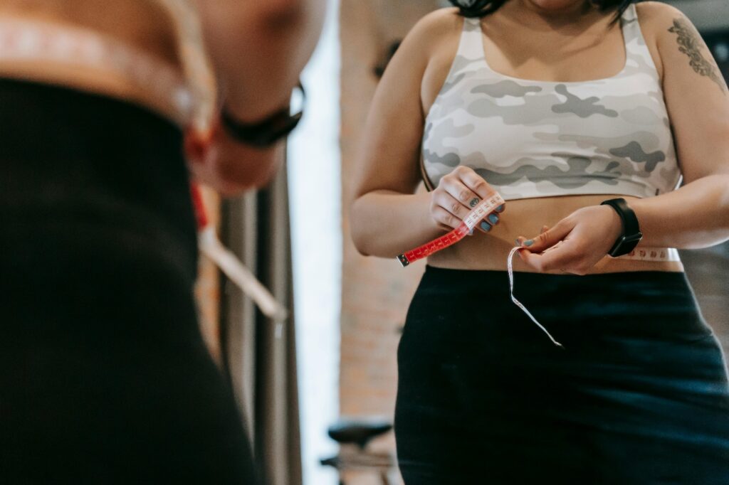 A person measuring their waist