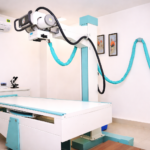 Modern X-ray room in a pathology lab with advanced digital radiology machine and patient examination table