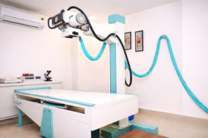 Modern X-ray room in a pathology lab with advanced digital radiology machine and patient examination table