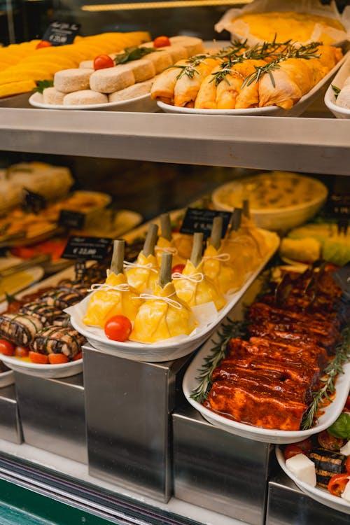 A vibrant deli window display with meat and specialty ingredients arranged for sale
