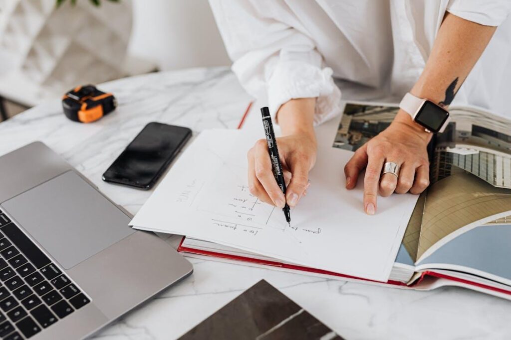 An image of a woman writing something on white paper