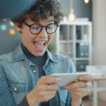 A player excitedly playing a game on her phone