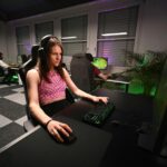 A player focused on gameplay on their computer