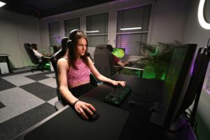 A player focused on gameplay on their computer