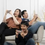 A trio playing sweepstakes games together on their phones