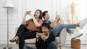 A trio playing sweepstakes games together on their phones