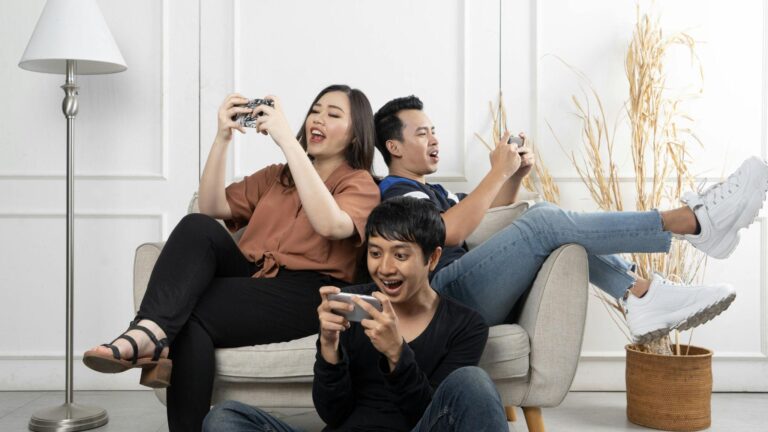 A trio playing sweepstakes games together on their phones