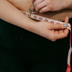 A person measuring their waist