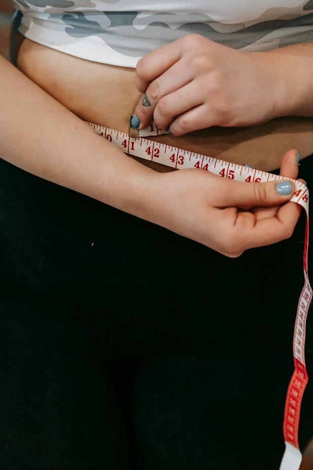 A person measuring their waist