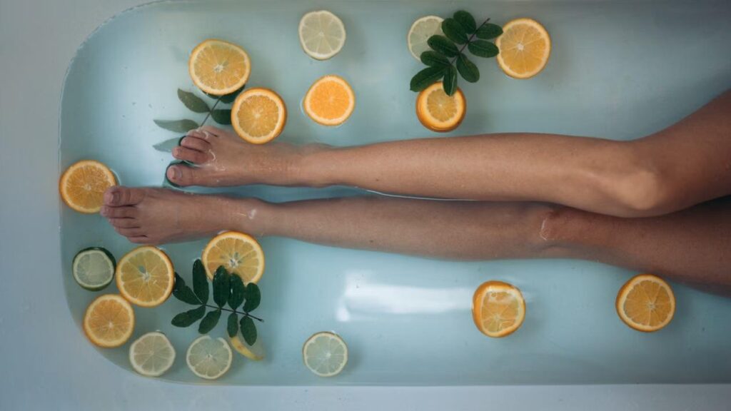 A person in a bathtub filled with orange slices.