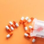 An image of capsules on an orange background