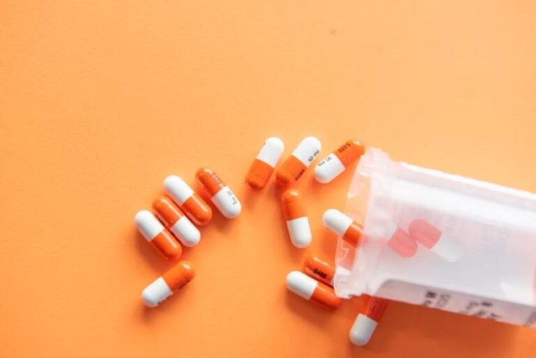 An image of capsules on an orange background