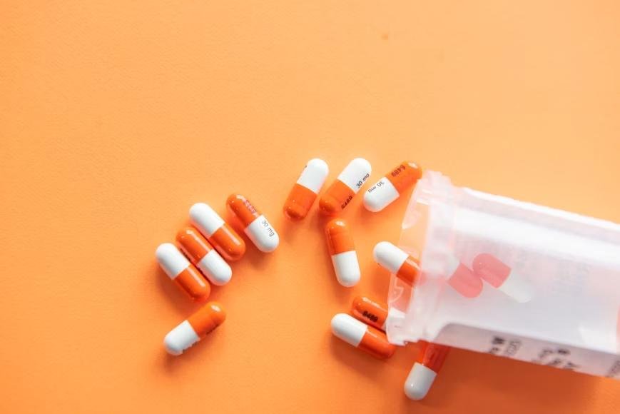 An image of capsules on an orange background