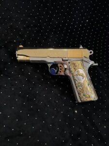 Colt 45 ACP featuring a two-tone 24K gold slide with polished stainless steel