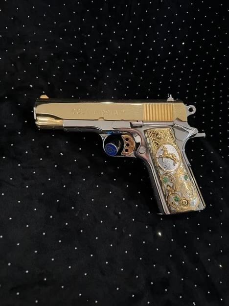 Colt 45 ACP featuring a two-tone 24K gold slide with polished stainless steel