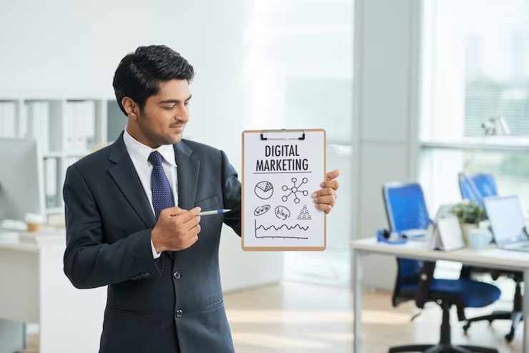 imgi_7_man-suit-standing-office-with-clipboard-pointing-poster-with-words_1098-17121