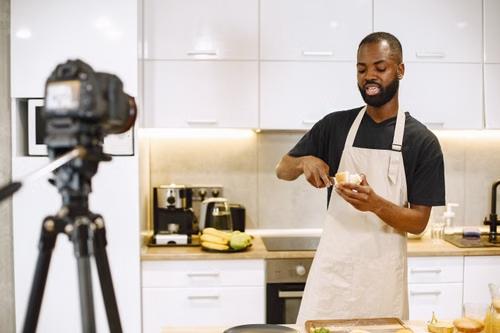 Influencer recording a kitchenware product review in front of a camera