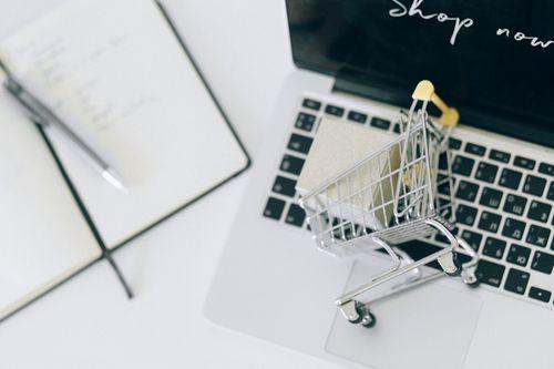 Mini shopping cart placed on a laptop keyboard