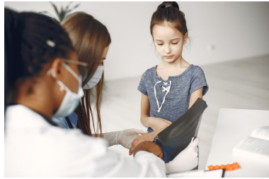 An image of a young girl having a checkup at a clinic
