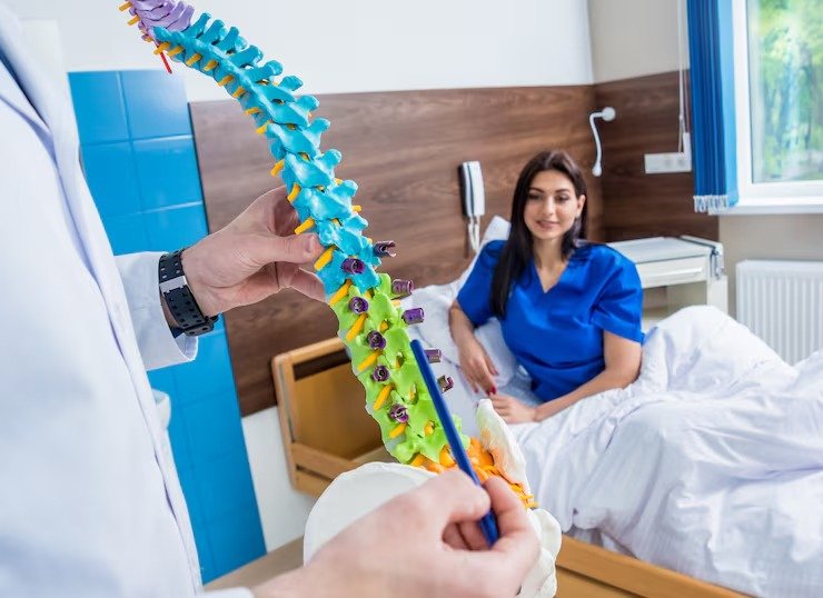 imgi_10_orthopedist-showing-spine-model-patient-hospital_179755-8378