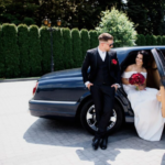 A bride stepping out of a limousine on her wedding.