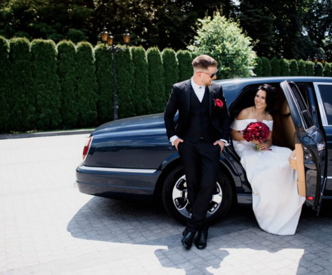 A bride stepping out of a limousine on her wedding.