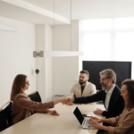 two businesspeople shaking hands after a meeting