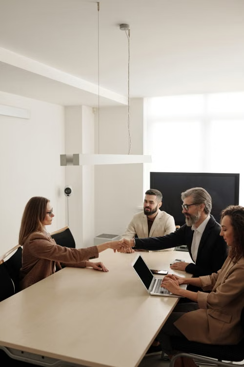 two businesspeople shaking hands after a meeting