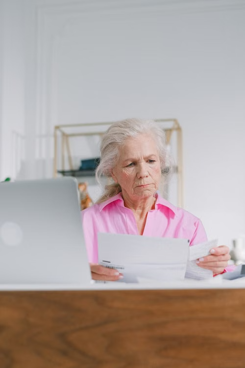 elderly woman looking at documents