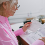 elderly woman reading a document