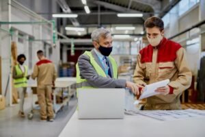 imgi_12_mid-adult-engineer-male-worker-wearing-face-masks-while-examining-paperwork-woodworking-factory_637285-11899