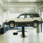 Vehicle raised on a lift inside an independent auto repair shop