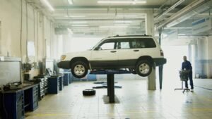 Vehicle raised on a lift inside an independent auto repair shop