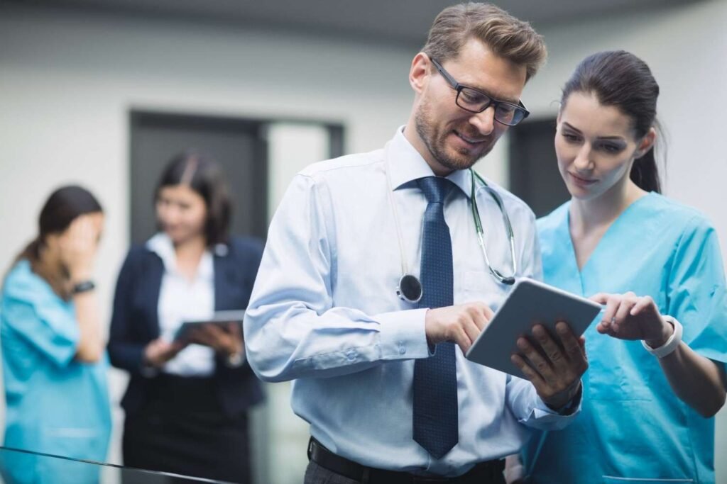 doctor-nurse-discussing-digital-tablet-90kb