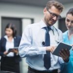 doctor-nurse-discussing-digital-tablet-90kb